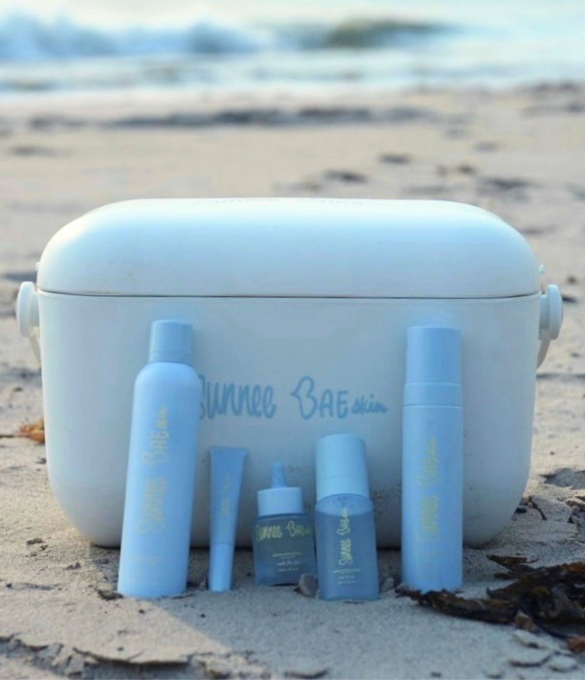 White Sunnee BAEskin Cooler with five blue Sunnee BAE products 